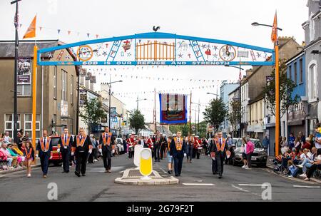 DUP leader Sir Jeffrey Donaldson MP (second from right at front of group) marching as a member of Ballinran Orange Lodge through Kilkeel, Co. Down, as part of the annual Twelfth of July celebrations, marking the victory of King William III's victory over James II at the Battle of the Boyne in 1690. Picture date: Monday July 12, 2021. Stock Photo