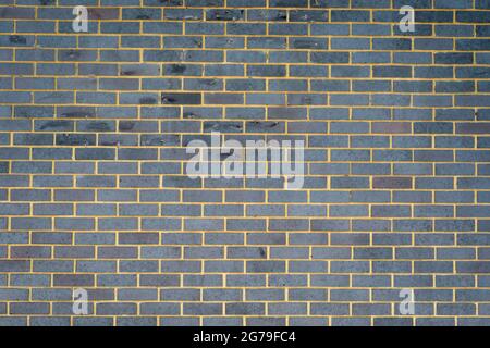 Grey brick external wall, background. Stock Photo