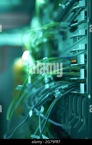 Side view close up of cables and wires connecting servers in supercomputer or data center, copy space Stock Photo