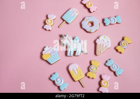 Flat lay composition with bright glazed gingerbread cookies on pink background. Stock Photo