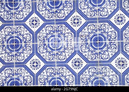 Traditional glazed blue and white ceramic tiles or azulejos which cover many buildings in Lisbon, Portugal.