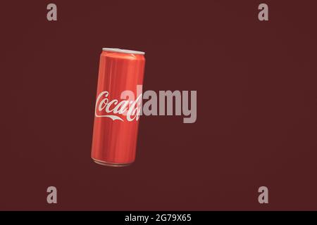 KALININGRAD, RUSSIA - MARCH 13, 2021 - Coca Cola can, red background. Classic coke jar, carbonated soft drink. Manufactured by The Coca-Cola Company. Stock Photo