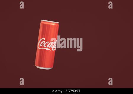 KALININGRAD, RUSSIA - MARCH 13, 2021 - Coca Cola can, red background. Classic coke jar, carbonated soft drink. Manufactured by The Coca-Cola Company. Stock Photo