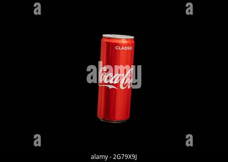 KALININGRAD, RUSSIA - MARCH 13, 2021 - Coca Cola can, black background. Classic coke jar, carbonated soft drink. Manufactured by The Coca-Cola Company Stock Photo