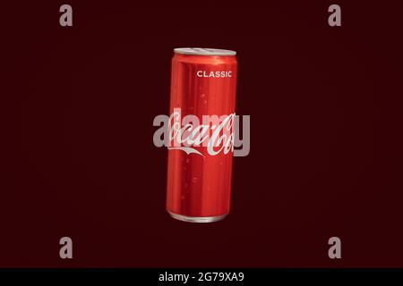 KALININGRAD, RUSSIA - MARCH 13, 2021 - Coca Cola can, red background. Classic coke jar, carbonated soft drink. Manufactured by The Coca-Cola Company. Stock Photo