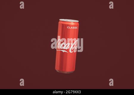 KALININGRAD, RUSSIA - MARCH 13, 2021 - Coca Cola can, red background. Classic coke jar, carbonated soft drink. Manufactured by The Coca-Cola Company. Stock Photo