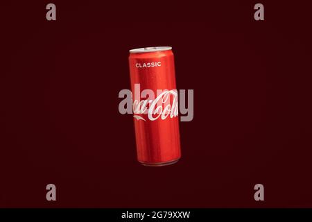 KALININGRAD, RUSSIA - MARCH 13, 2021 - Coca Cola can, red background. Classic coke jar, carbonated soft drink. Manufactured by The Coca-Cola Company. Stock Photo