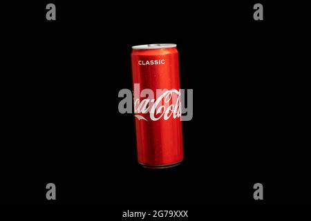 KALININGRAD, RUSSIA - MARCH 13, 2021 - Coca Cola can, black background. Classic coke jar, carbonated soft drink. Manufactured by The Coca-Cola Company Stock Photo