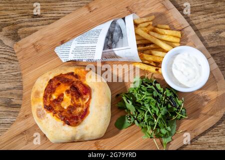 Sheffield, UK : 9 Oct 2017 : American diner food - pizza burger and fries at Wagon 1871, Leadmill Road Stock Photo