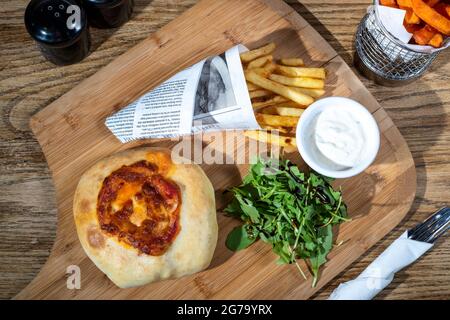 Sheffield, UK : 9 Oct 2017 : American diner food - pizza burger and fries at Wagon 1871, Leadmill Road Stock Photo