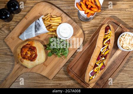 Sheffield, UK : 9 Oct 2017 : American diner food - pizza burger, hotdog & fries at Wagon 1871, Leadmill Road Stock Photo