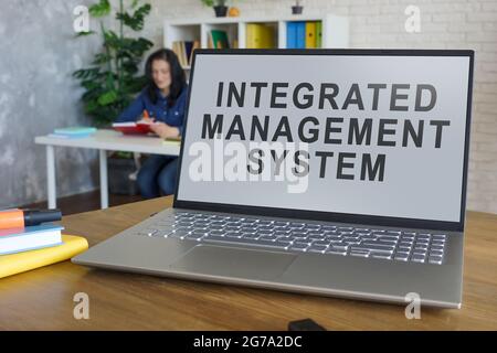 Laptop with integrated management system in the office. Stock Photo
