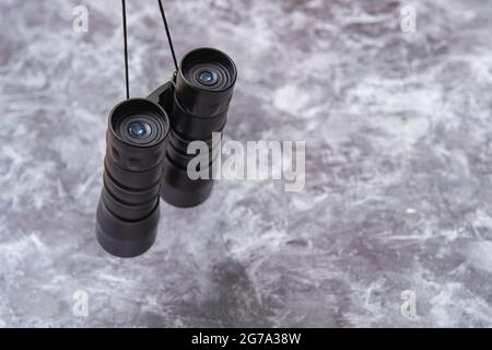 Binoculars on a grey background Stock Photo