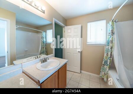 Interior of a bathroom with ceramic tile flooring and window Stock Photo