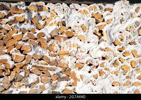 Snow-covered firewood store. Stock Photo