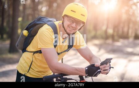 Man on bicycle checking gps navigator Stock Photo