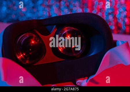 Virtual reality helmet on white background in neon light. VR, future, gadgets, technology concept. Stock Photo