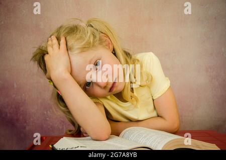 sad blond girl with open book Stock Photo