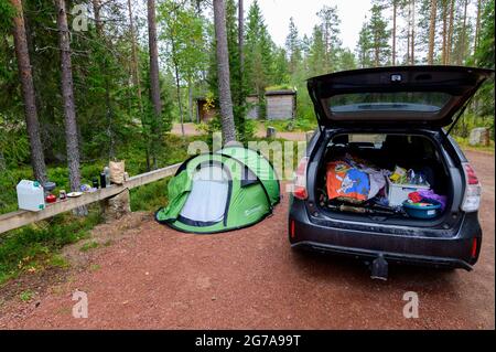 Tourist pop up tent and a car on a parking place in Hamra National Park, Sweden Stock Photo