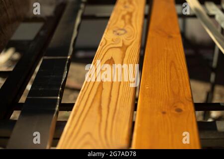 Planks in a woodworking workshop. The boards are ready for work. Lumber is on the table. Prepared fittings. Stock Photo