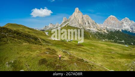 Aerial view of a man at Giau Pass enjoying Monte Nuvolau mountans. Dolomites, Italy Stock Photo