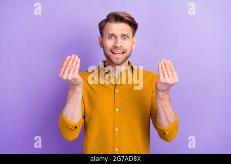 Portrait of unsatisfied person arms fingers show money symbol tell speak isolated on purple color background Stock Photo