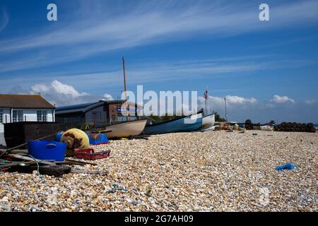 Fishing gear and boats including ropes, pots, buoys and tackle on East Beach Selsey in Southern England. Stock Photo