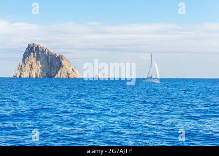 Sailing boat at Basiluzzo cliff, Panarea, Aeolian Islands, Sicily, Italy Stock Photo