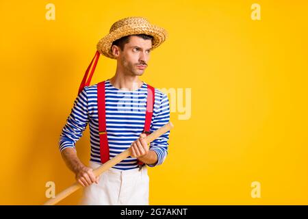 Photo of young handsome man hold wooden paddle look empty space kayak isolated on yellow color background Stock Photo