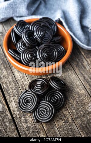 Spiral from liquorice candy on wooden table. Stock Photo