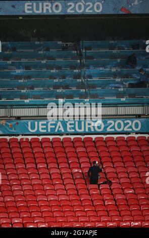 London, UK. 12th July, 2021. Football: European Championship, Italy - England, final round, final at Wembley Stadium. A single journalist stands in the stands working long after the match is over. Credit: Christian Charisius/dpa/Alamy Live News Stock Photo