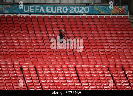 London, UK. 12th July, 2021. Football: European Championship, Italy - England, final round, final at Wembley Stadium. A single journalist stands in the stands working long after the match is over. Credit: Christian Charisius/dpa/Alamy Live News Stock Photo