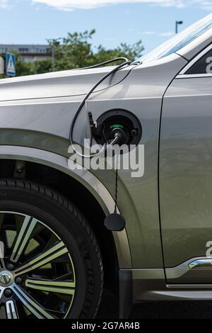 Gothenburg, Sweden - June 13 2021: A Plug in hybrid Volvo car charging at a public charging station Stock Photo