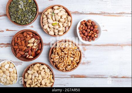Different kind of nuts in wooden bowls Stock Photo