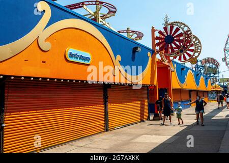 Closed businesses on Jones Walk in Coney Island in Brooklyn in New York over the long Independence Day weekend, Monday, July 5, 2021.  (© Richard B. Levine)