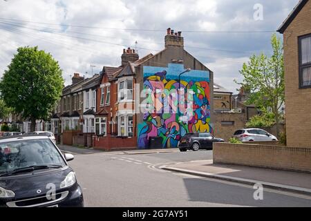 Colourful abstract mural on the gable end of a row of terraced housing in Walthamstow East London E17 UK   KATHY DEWITT Stock Photo