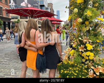 Visitors crowd the L.E.A.F. Festival of Flowers in the Meatpacking District in New York on Saturday, June 12, 2021. With over 100 florists participating and a million flowers the Meatpacking District was blanketed with floral installations. (© Frances M. Roberts) Stock Photo