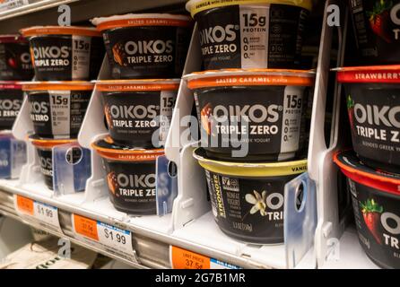 Containers of Dannon's Oikos brand greek style yogurt are seen on a supermarket shelf in New York on Tuesday, July 6, 2021. Danone North America is reported to be rebranding and reformulating the yogurt. (© Richard B. Levine) Stock Photo