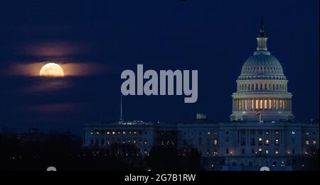 The Moon, or supermoon, is seen as it rises behind the U.S. Capitol, Monday, March 9, 2020, in Washington, DC. A supermoon occurs when the Moon's orbit is closet (perigee) to Earth.  A unique, optimised and digitally enhanced version of an NASA image by J Kowsky/ credit NASA Stock Photo
