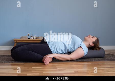 Pregnant woman practicing yoga in suptha virasana exercise Stock Photo