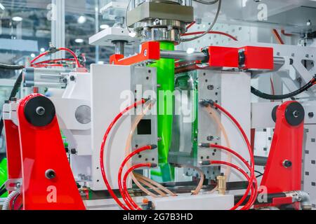 Automatic blow molding machine: manufacturing of empty green plastic jerrycans Stock Photo