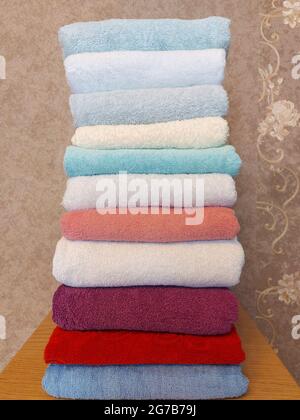 Multi-colored cotton terry towels are stacked Stock Photo