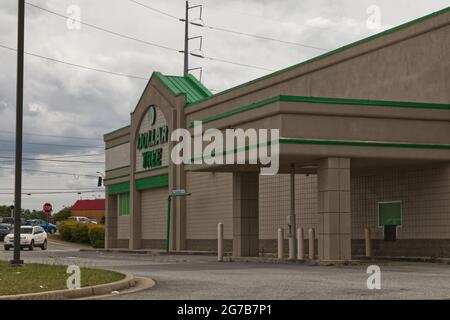 Augusta, Ga USA - 04 15 21:  Side view of Dollar Tree retail store and traffic in the background with storm clouds - Windsor Spring Road Stock Photo