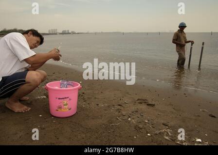 East Ancol, Jakarta, Indonesia. 2nd June 2009. Scientists from the Indonesian Institute of Sciences (LIPI) are working with research instruments on the beach, which is a part of a series of their research activities to find out, among others, how far the sea water infiltration has impacted the groundwater source quality in the city of Jakarta, Indonesia. Jakarta has been suffering from land subsidence, sea water infiltration and floods. Stock Photo