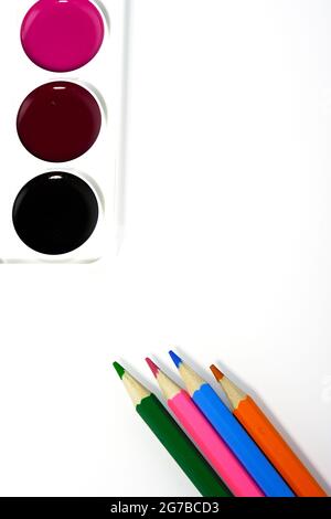 Pencils and watercolors, on a white background, top view Stock Photo