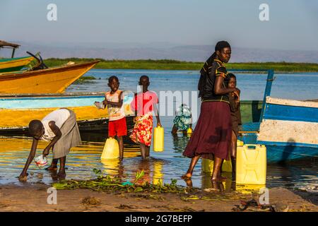 Children filling water in canisters at Lake Albert, Uganda, Africa Stock Photo