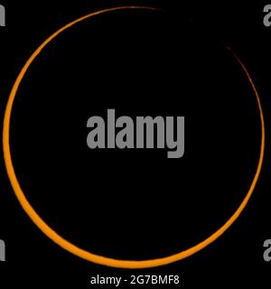 Third contact of an annular solar eclipse where lunar mountains let sun light passing through Stock Photo