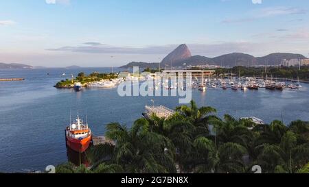 Rio de Janeiro Sugar Loaf aerial view from MAM area in Gloria, above palm trees, view on the Guanabara Bay with yacht marina & Sugar Loaf in distance Stock Photo