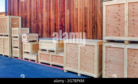 Pano Crate container boxes against exterior wall and ventilator window of building Stock Photo