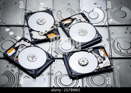 a shot of many cover removed hard drive show magnetic disc inside lay on many harddisks Stock Photo